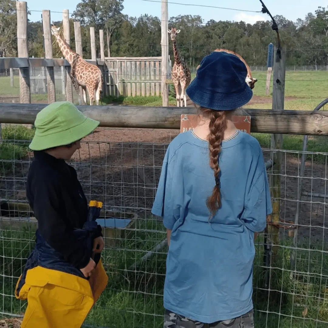Children looking at giraffes at a wildlife park on a 4titude school holiday excursion