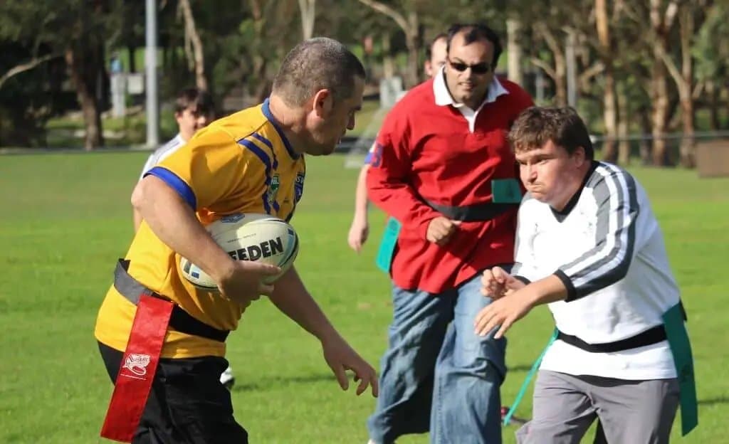 4titude Scorpions participants playing sport on a grass field, NDIS-funded inclusive sport in action